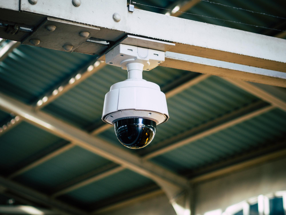 Low angle view of security camera hanging from ceiling in train station berlin